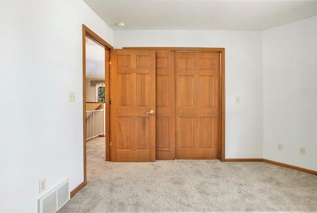 unfurnished bedroom with light carpet