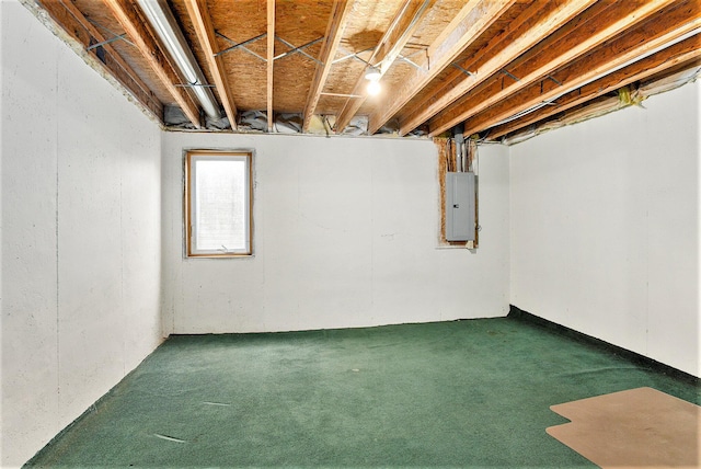 basement with electric panel and dark colored carpet