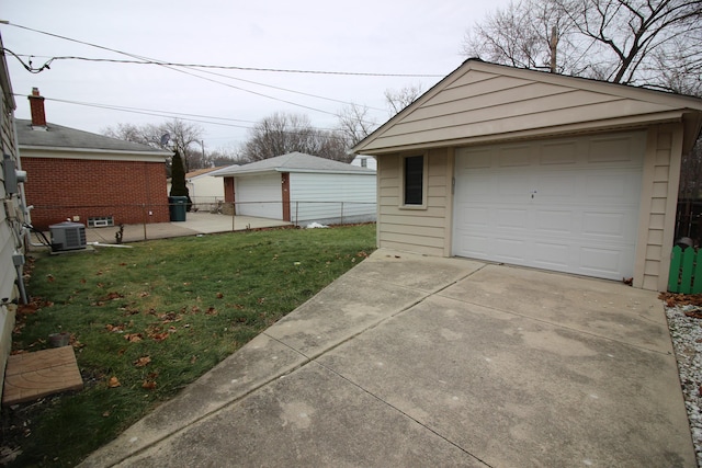 garage with cooling unit and a lawn