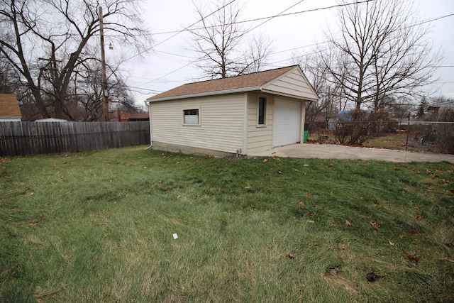 view of outbuilding with a garage and a lawn