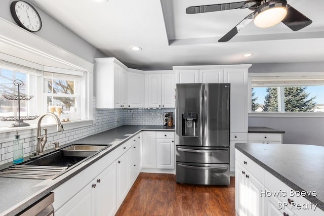 kitchen with stainless steel appliances, dark hardwood / wood-style floors, sink, and white cabinets