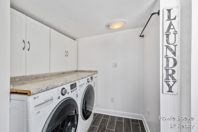 laundry area with independent washer and dryer and cabinets