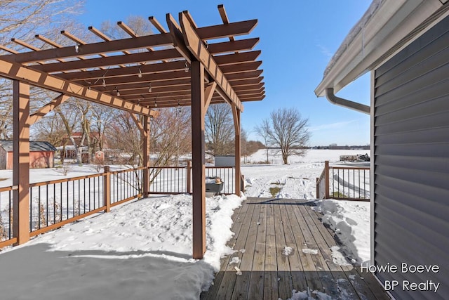 snow covered deck with a pergola