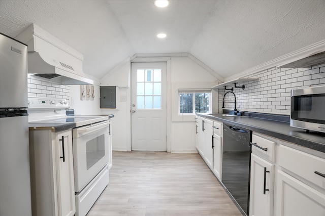 kitchen featuring lofted ceiling, sink, appliances with stainless steel finishes, white cabinetry, and light wood-type flooring