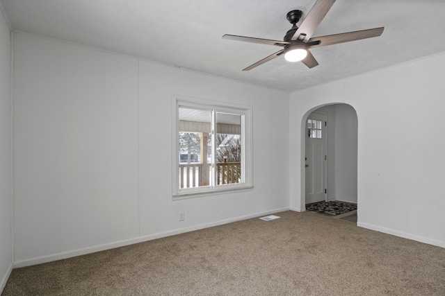 spare room featuring ceiling fan, carpet, and a textured ceiling