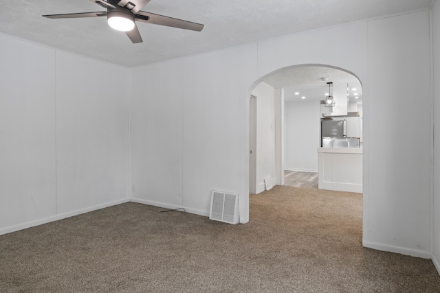 empty room with ceiling fan and carpet flooring