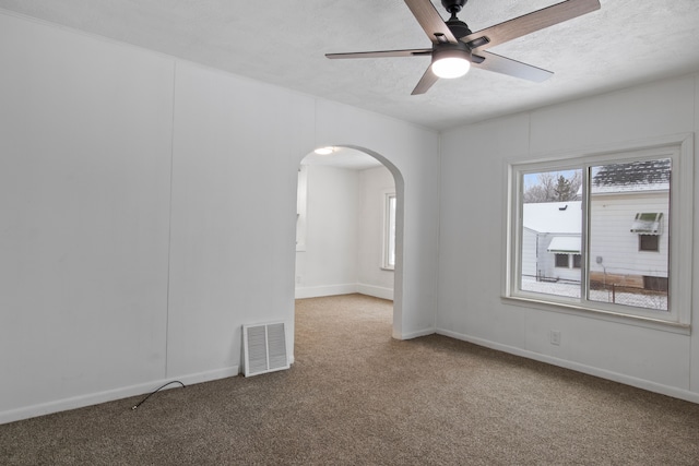 unfurnished room featuring ceiling fan, carpet floors, and a textured ceiling