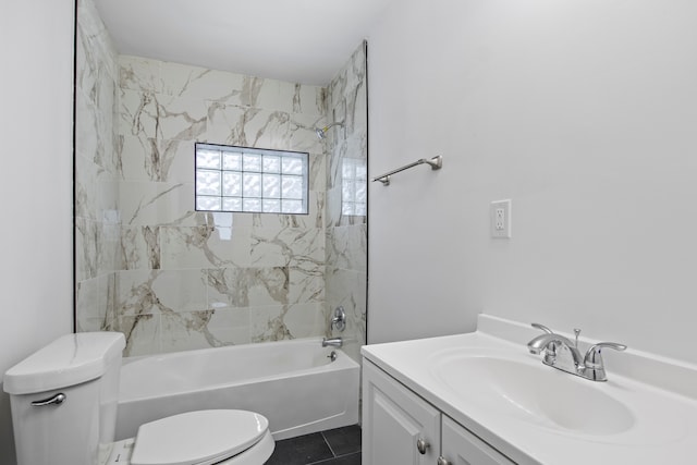 full bathroom with tile patterned flooring, tiled shower / bath, vanity, and toilet