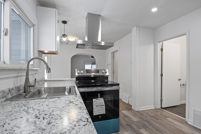 kitchen with pendant lighting, sink, dark hardwood / wood-style floors, island exhaust hood, and stainless steel range with electric cooktop