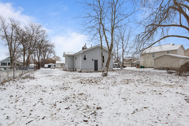 view of snow covered back of property