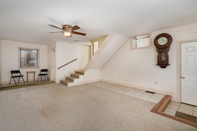 interior space with carpet floors, ceiling fan, and plenty of natural light