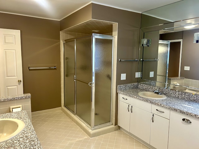 bathroom with vanity, ornamental molding, tile patterned floors, and walk in shower