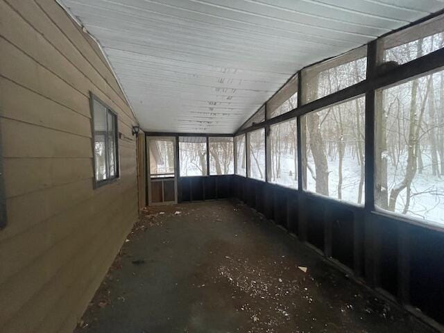 unfurnished sunroom with lofted ceiling