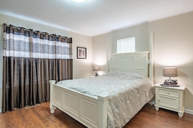 bedroom featuring dark hardwood / wood-style flooring