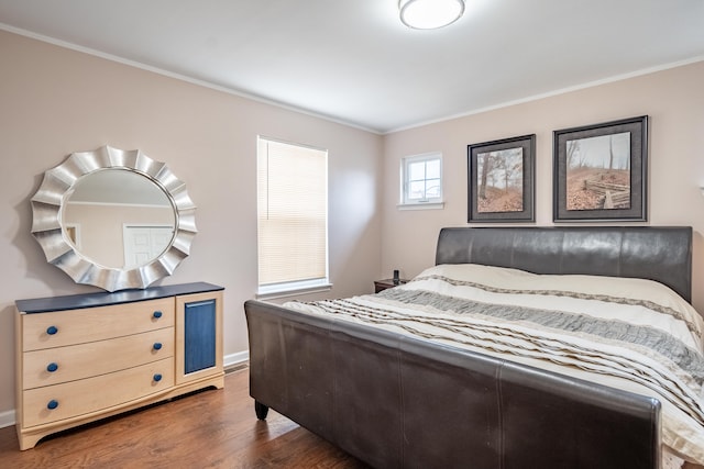 bedroom with dark hardwood / wood-style flooring and crown molding