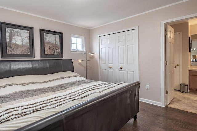 bedroom with ornamental molding, dark wood-type flooring, and a closet