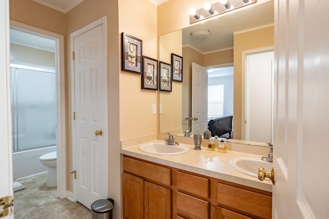 full bathroom with vanity, ornamental molding, shower / bath combination with glass door, and toilet