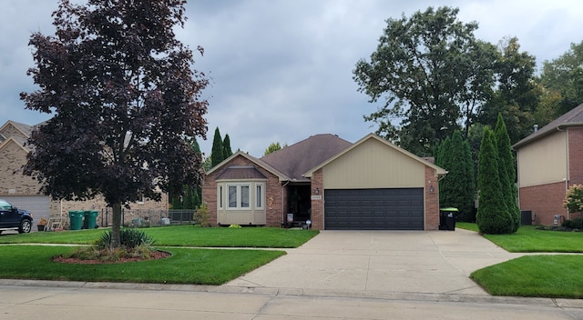 single story home with a garage and a front lawn