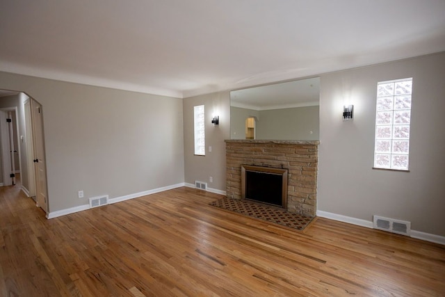 unfurnished living room with hardwood / wood-style flooring and a fireplace