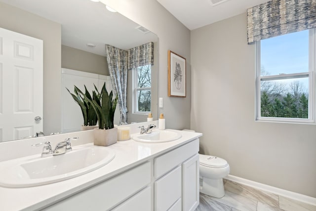 bathroom featuring vanity and toilet