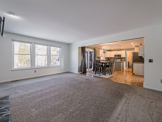 unfurnished living room featuring carpet