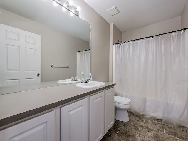 full bathroom featuring vanity, shower / bath combination with curtain, and toilet