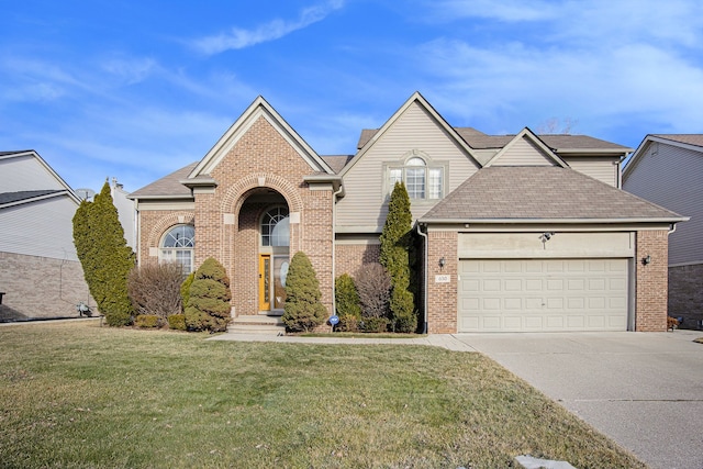 view of front property featuring a garage and a front yard