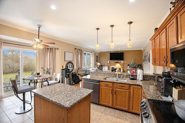 kitchen featuring light tile patterned floors, stainless steel appliances, sink, and a wealth of natural light