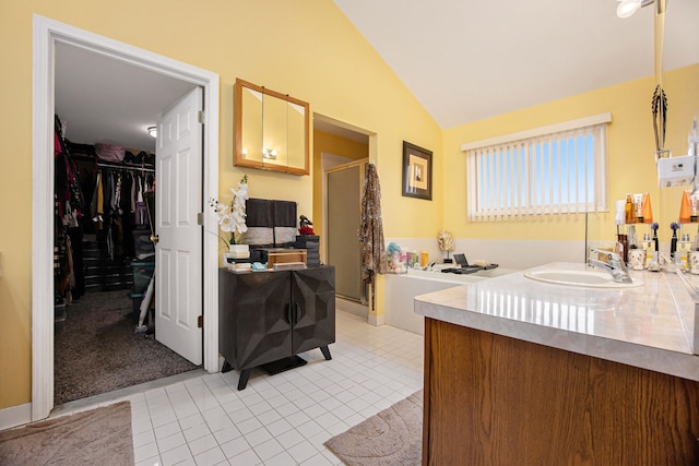 kitchen with lofted ceiling, sink, and light tile patterned floors