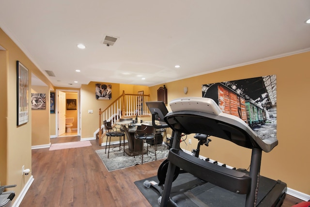 workout room featuring hardwood / wood-style flooring and ornamental molding