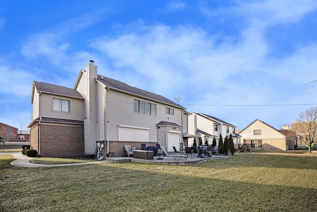 rear view of property with a yard and a patio area