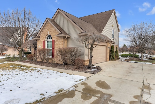 snow covered property with a garage