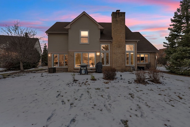 view of back house at dusk