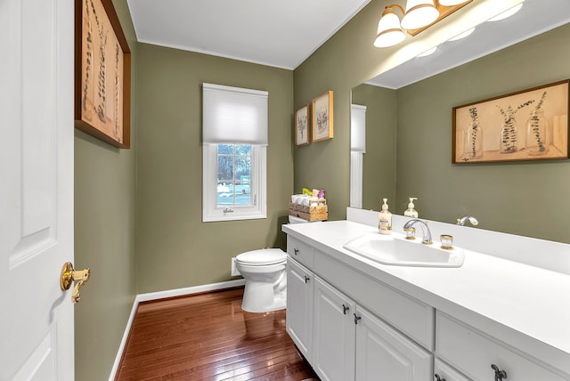 bathroom with hardwood / wood-style flooring, vanity, and toilet