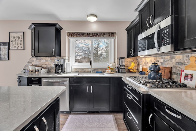 kitchen featuring stainless steel appliances, sink, and backsplash