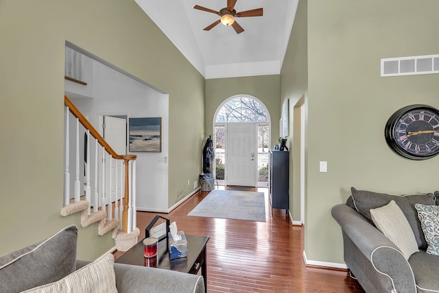 foyer featuring hardwood / wood-style flooring, ceiling fan, and high vaulted ceiling