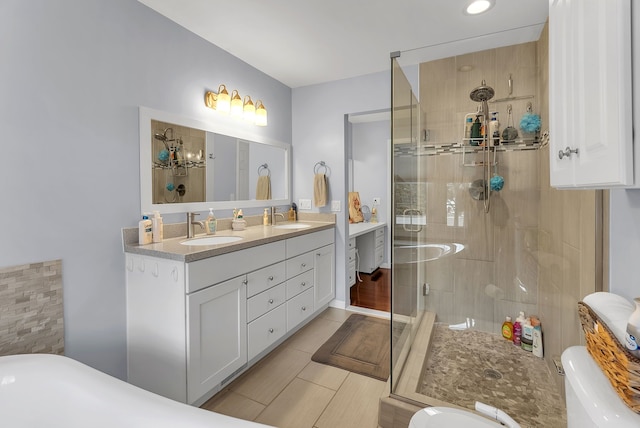 bathroom featuring vanity, toilet, and a shower with shower door