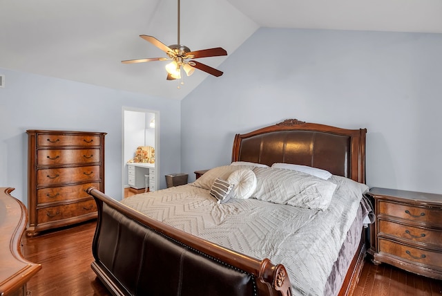 bedroom featuring ceiling fan, ensuite bathroom, dark hardwood / wood-style floors, and vaulted ceiling