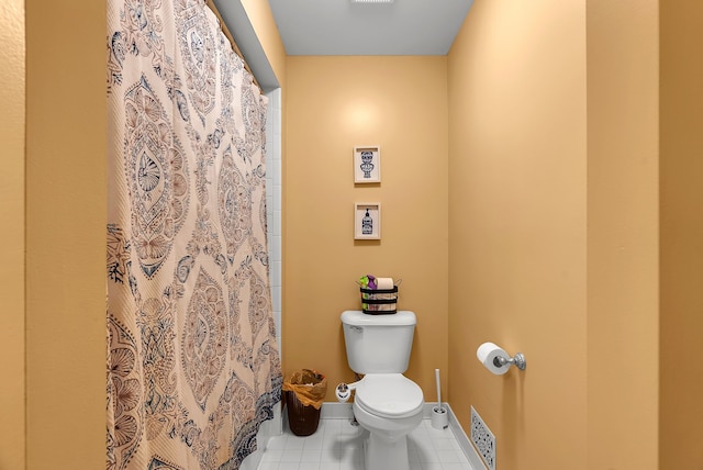 bathroom featuring tile patterned floors and toilet