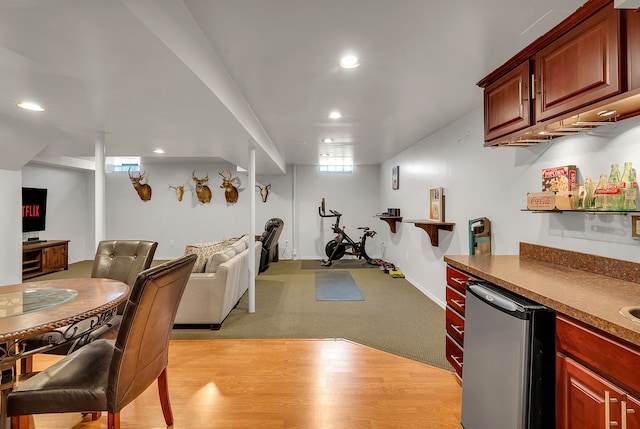 interior space featuring stainless steel fridge and light hardwood / wood-style floors