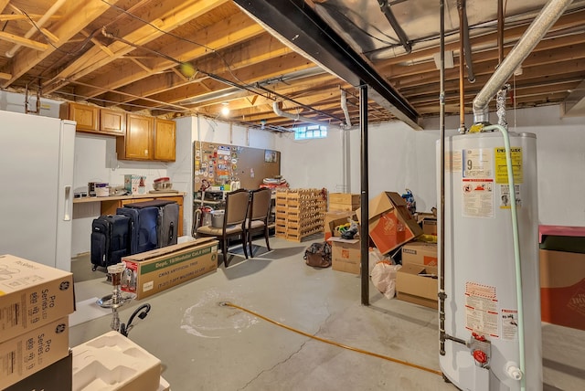 basement with white refrigerator with ice dispenser and gas water heater