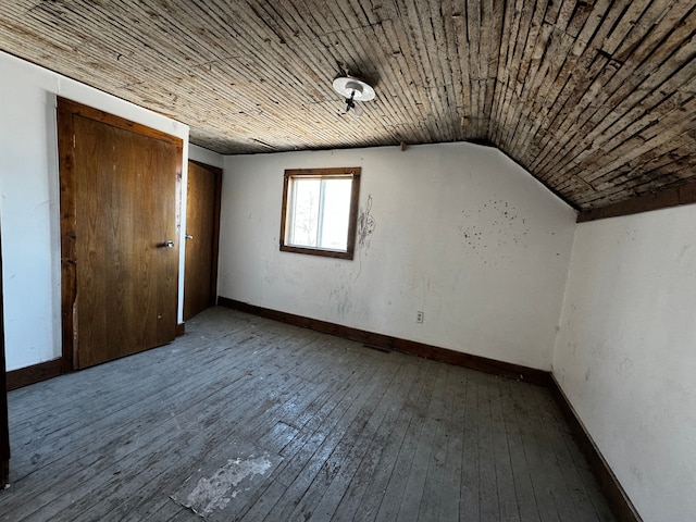 additional living space featuring wood ceiling, baseboards, vaulted ceiling, and hardwood / wood-style floors