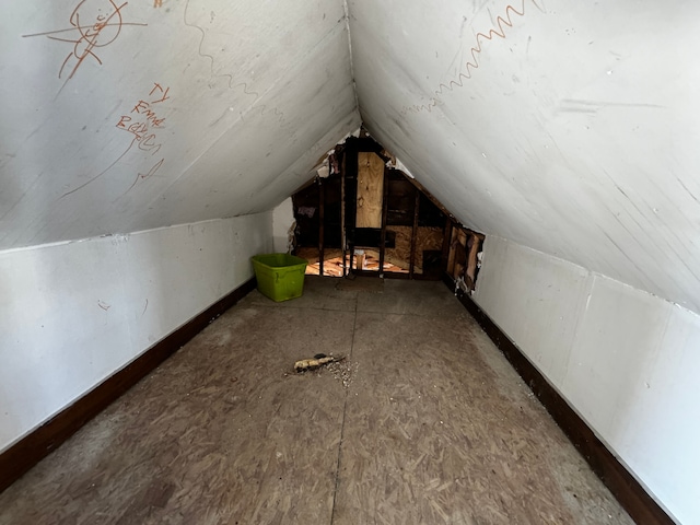 additional living space featuring lofted ceiling and baseboards