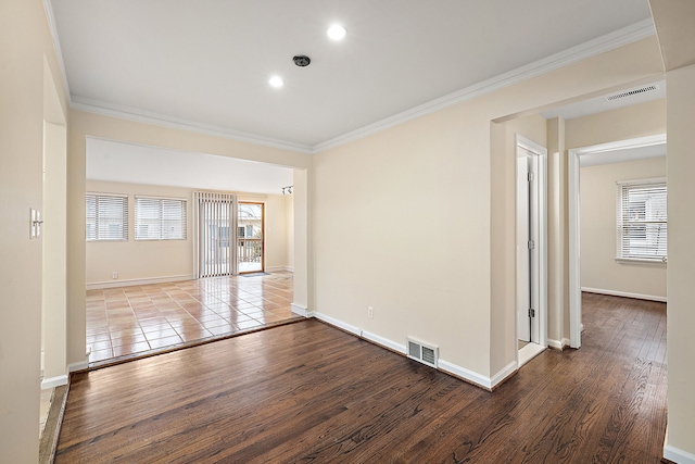 unfurnished room featuring wood-type flooring and ornamental molding