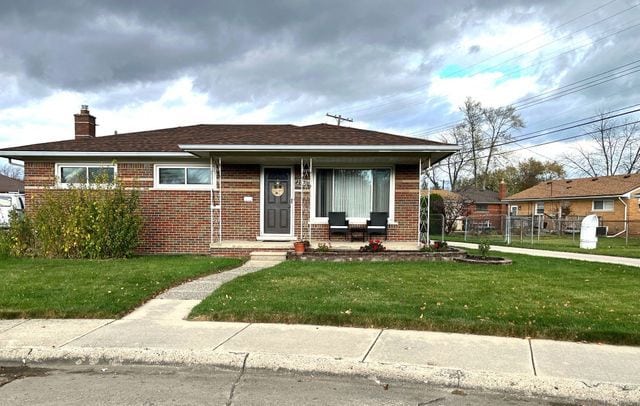 bungalow-style home with a front yard