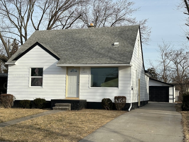 view of front of property with a garage and an outdoor structure