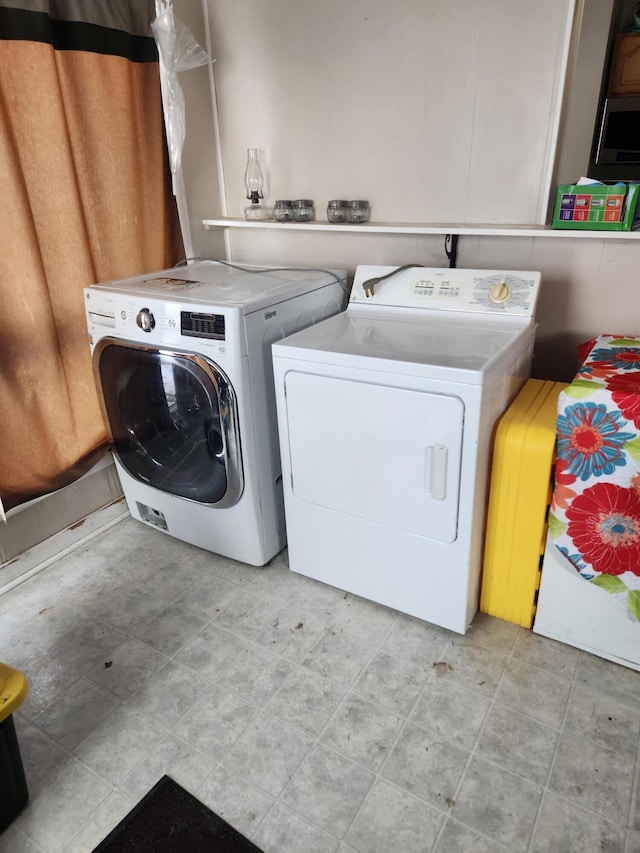 laundry room featuring washing machine and clothes dryer