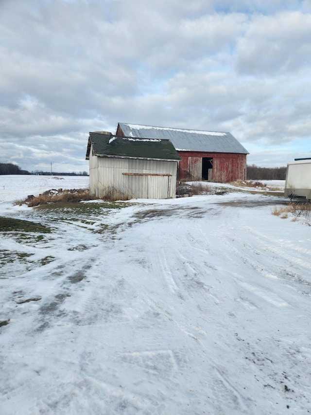 view of snow covered exterior featuring an outdoor structure