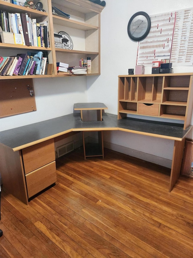 office space featuring built in desk and dark hardwood / wood-style floors