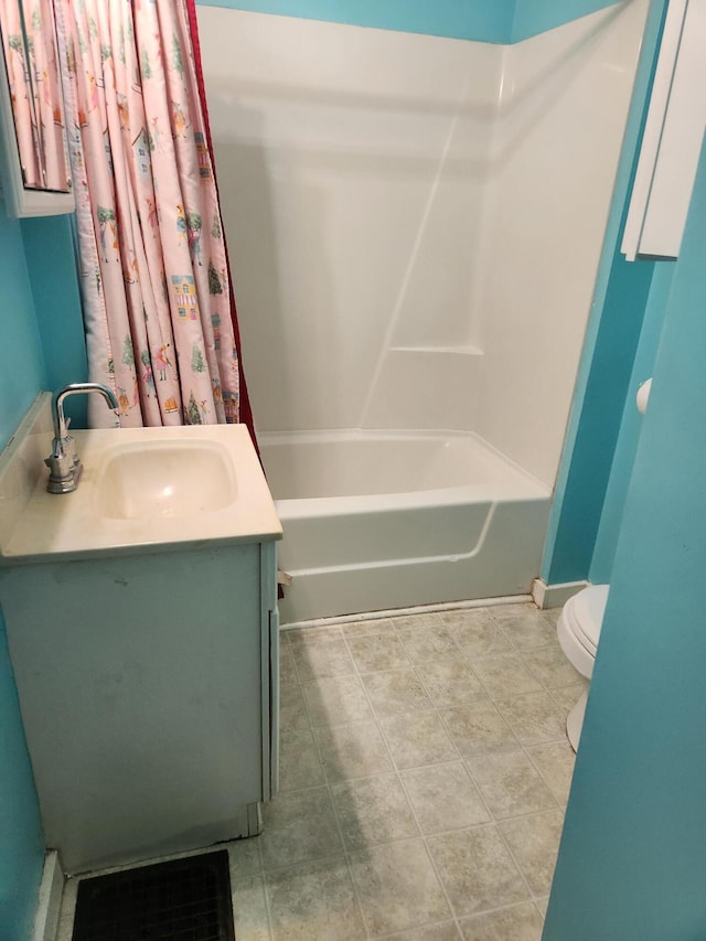 full bathroom featuring tile patterned floors, vanity, toilet, and shower / bath combo